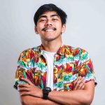 Young handsome man wearing casual shirt over white background happy face smiling with crossed arms looking at the camera. positive person.